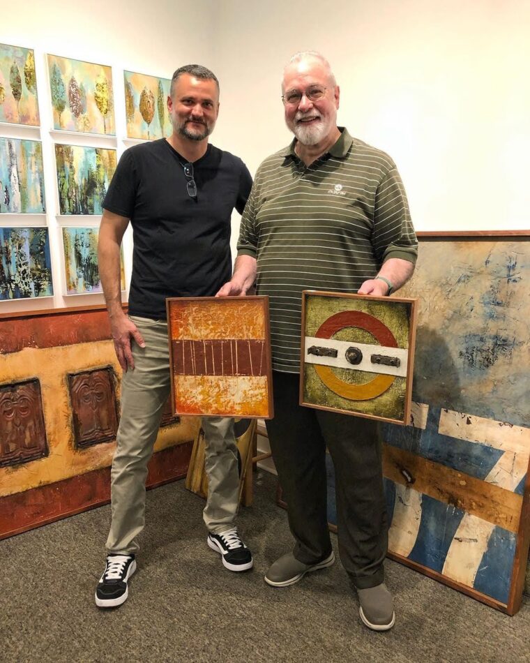 Domenick Naccarato along with an art collector taking home two small pieces of art.