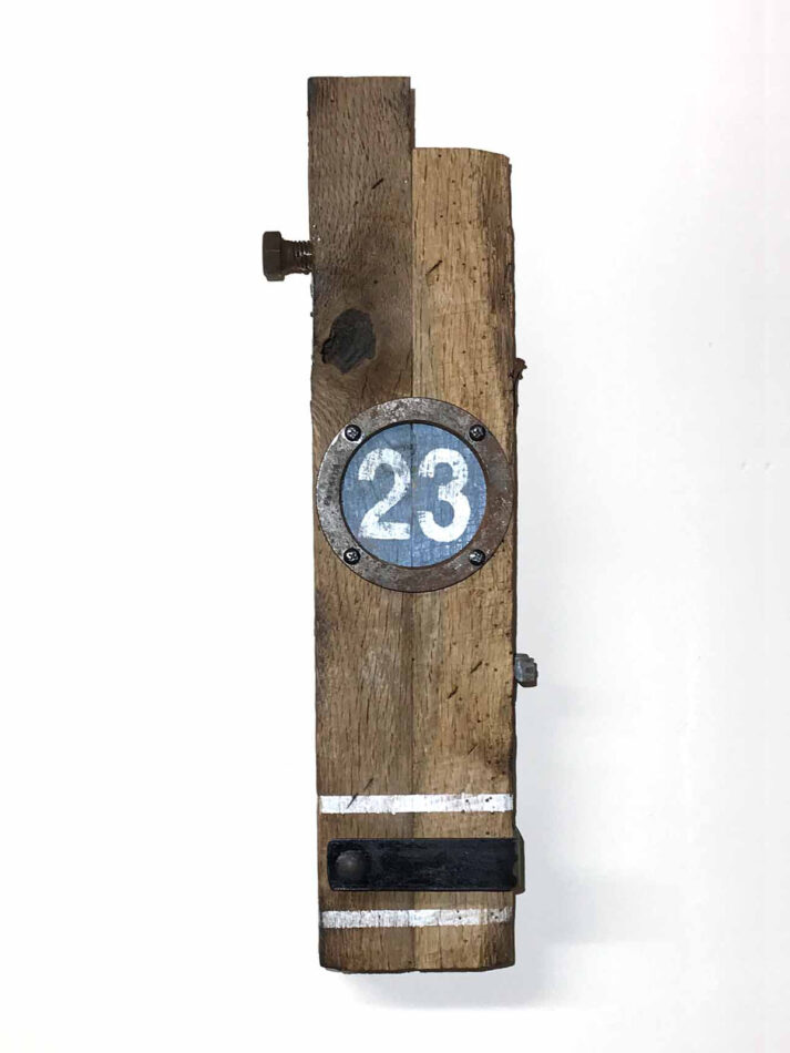 Remnants II: Twenty-Three, Assemblage No. 8 | Apx. 20"x6"x3" | bolt, faceplate ring, bracket, tube strap, screws, nails, epoxy, wood filler, and paint on barn wood | 2018