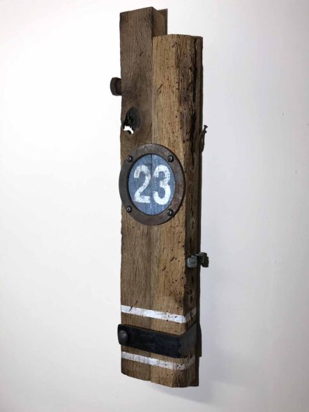 Remnants II: Twenty-Three, Assemblage No. 8 | Apx. 20"x6"x3" | bolt, faceplate ring, bracket, tube strap, screws, nails, epoxy, wood filler, and paint on barn wood | 2018