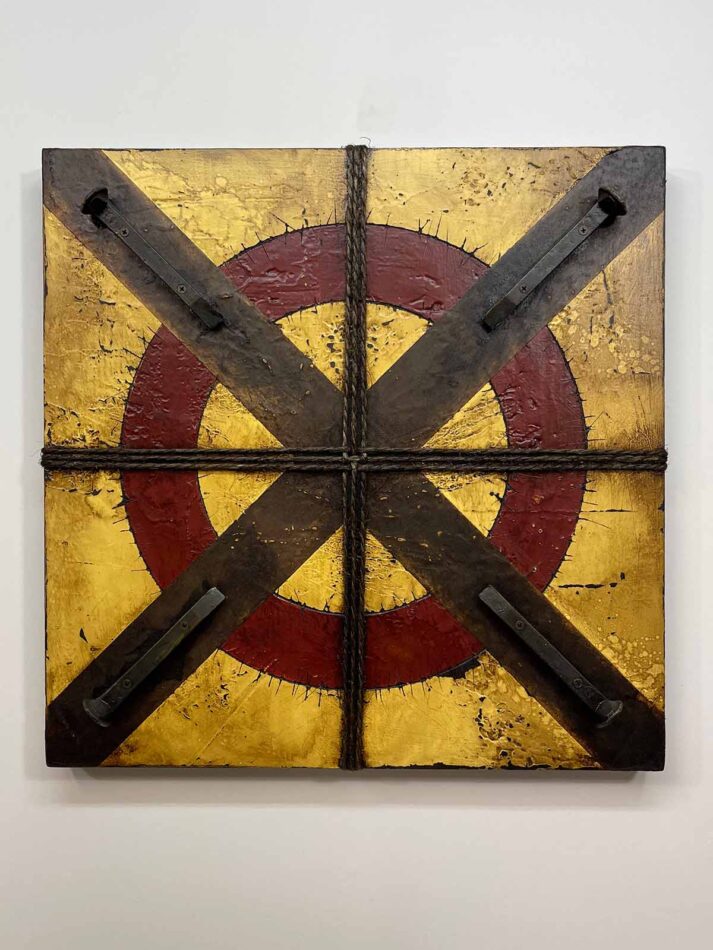 Assemblage wall art using railroad spikes, twine, and paint. Title: Circled X with Four Railroad Ties | 23.5"' x 23.5" | paint, joint compound, railroad spikes, screws, gummed paper tape, twine, oil stick, roofing tar, and polyurethane on plywood | 2021