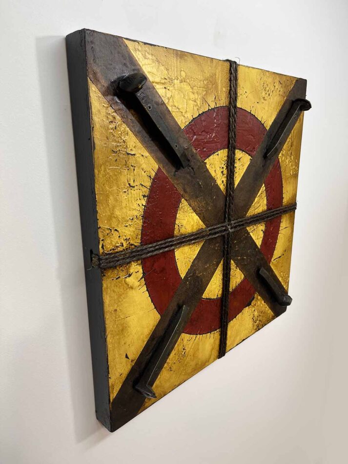 Assemblage wall art using railroad spikes, twine, and paint. Title: Circled X with Four Railroad Ties | 23.5"' x 23.5" | paint, joint compound, railroad spikes, screws, gummed paper tape, twine, oil stick, roofing tar, and polyurethane on plywood | 2021